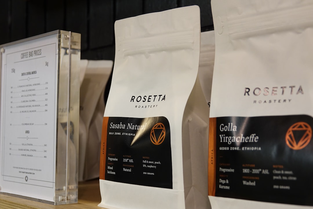Bags of freshly roasted coffee beans resting on shelves in the roastery